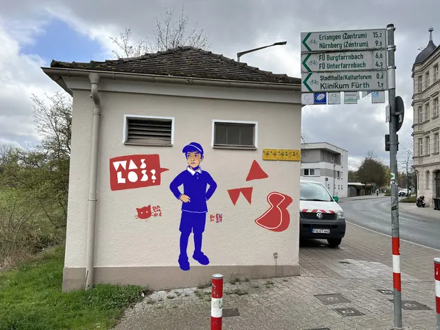 Graffitti mit Jungem und Sprechblase "Was los?"