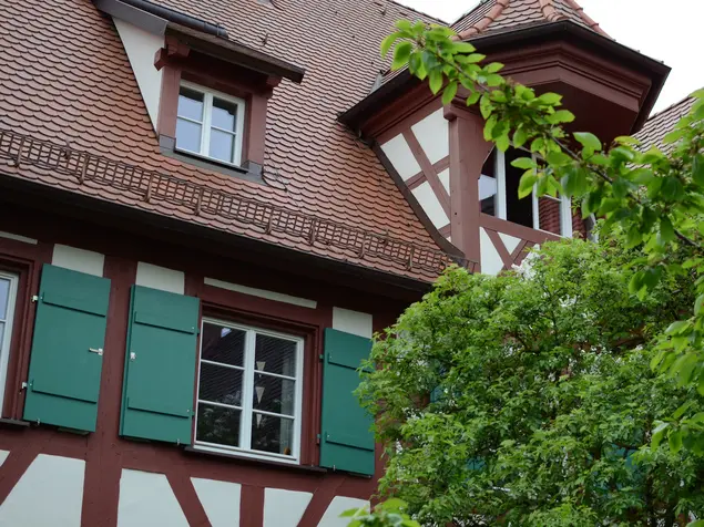 Fachwerkfassade mit hölzernen Fensterläden.