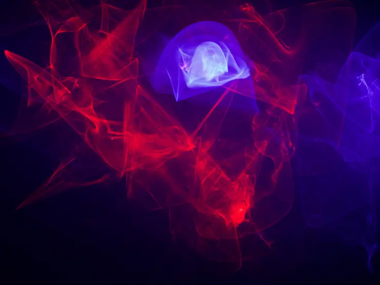 Abstrakte Darstellung von roten und blauen Lichtstrahlen, die in einem dunklen Hintergrund fließen und eine dynamische Bewegung suggerieren.